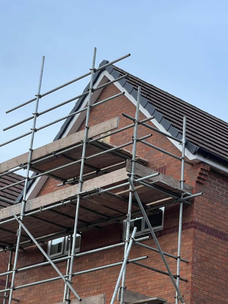 This is a photo of a roof which has just been repaired. There is a scaffold located at the gable end for access onto the roof. Works carried out by Mildenhall Roofing Repairs